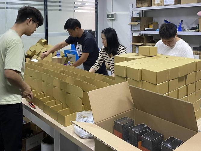 Team assembling kraft gift boxes and laying out samples before bulk production