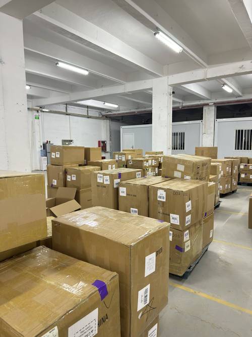 Warehouse holding labelled export cartons ready for door-to-door dispatch
